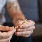 man rolling a joint