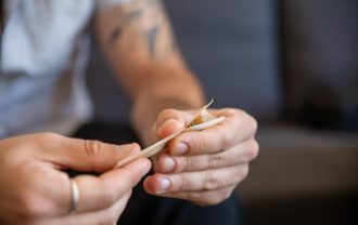 man rolling a joint